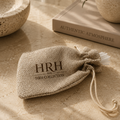 Textile bag with 'HRH The HRH Collection' branding on a textured surface.