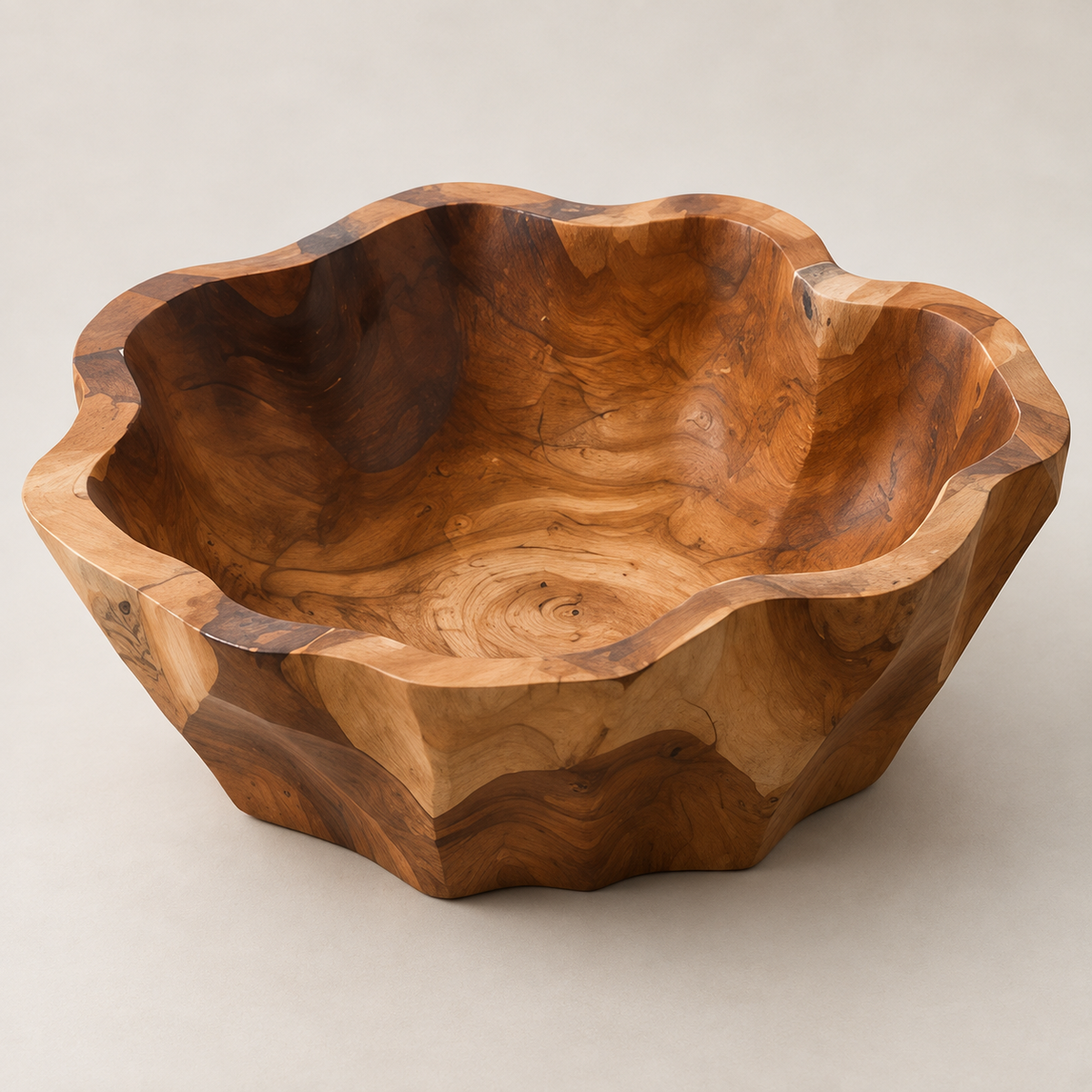 A handcrafted wooden salad bowl with a scalloped, organic edge and rich natural wood grain, photographed on a neutral light beige background.