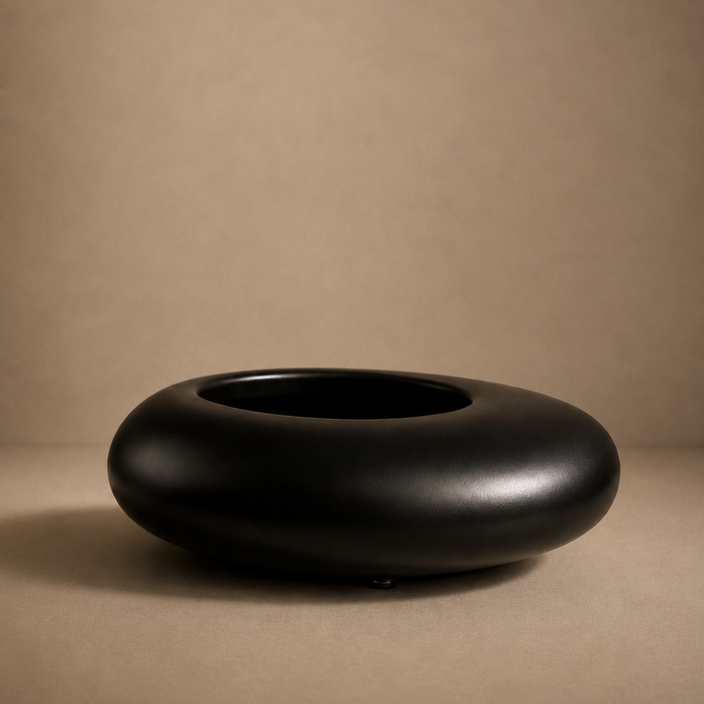 Black ceramic bowl on a beige background