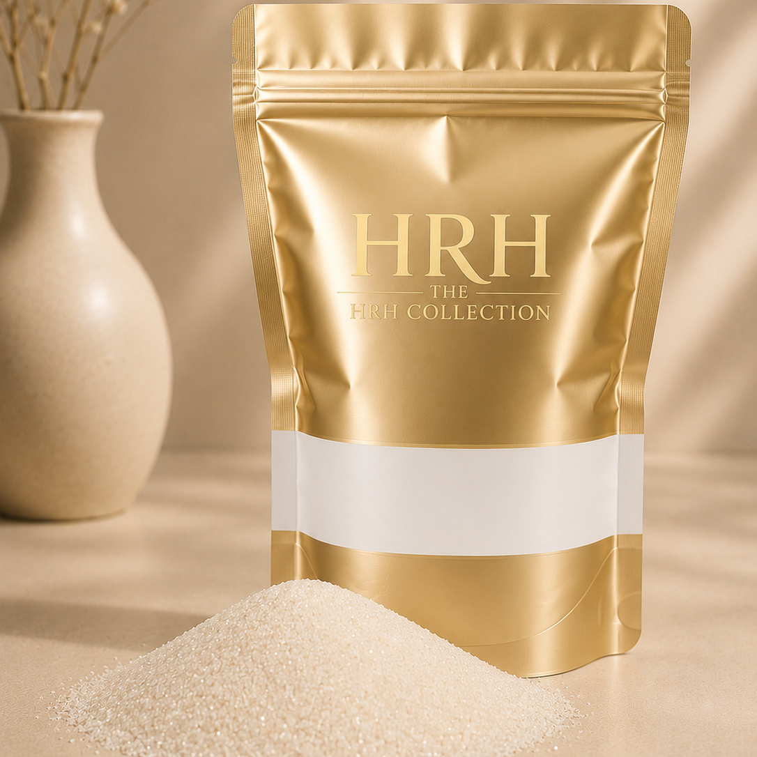 Gold packaging of HRH The White Collection with white powder on a beige background